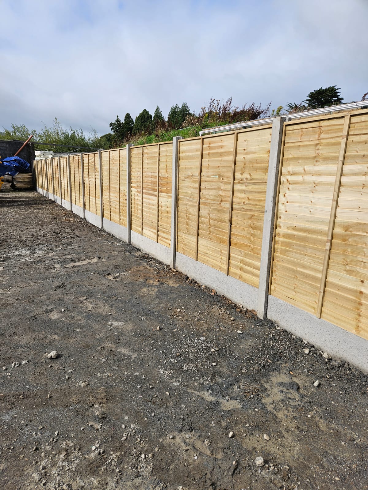 Long hand built garden fence