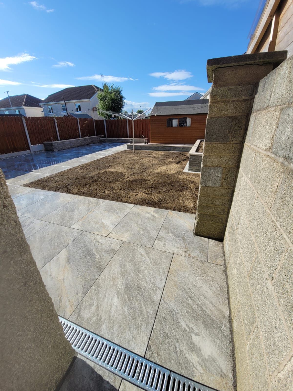 Paved back garden with an area for artificial grass