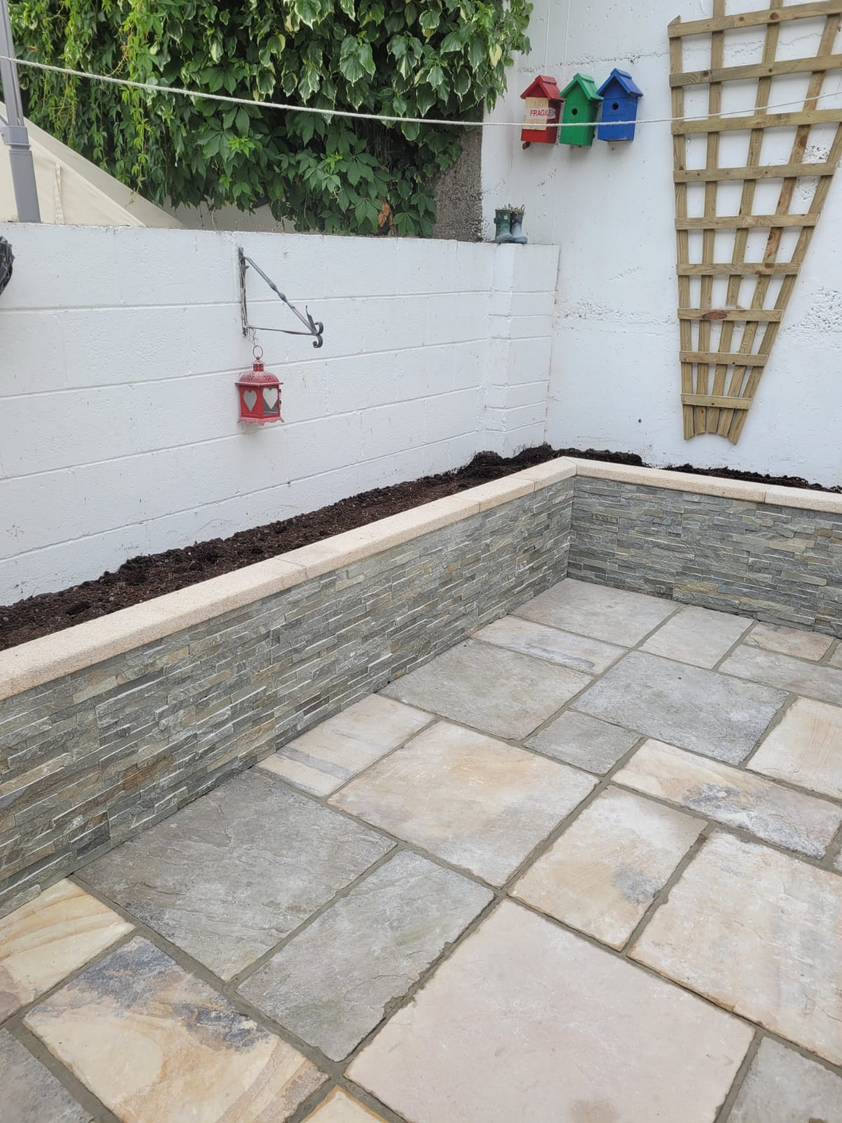 garden wall with a flower bed around the perimeter