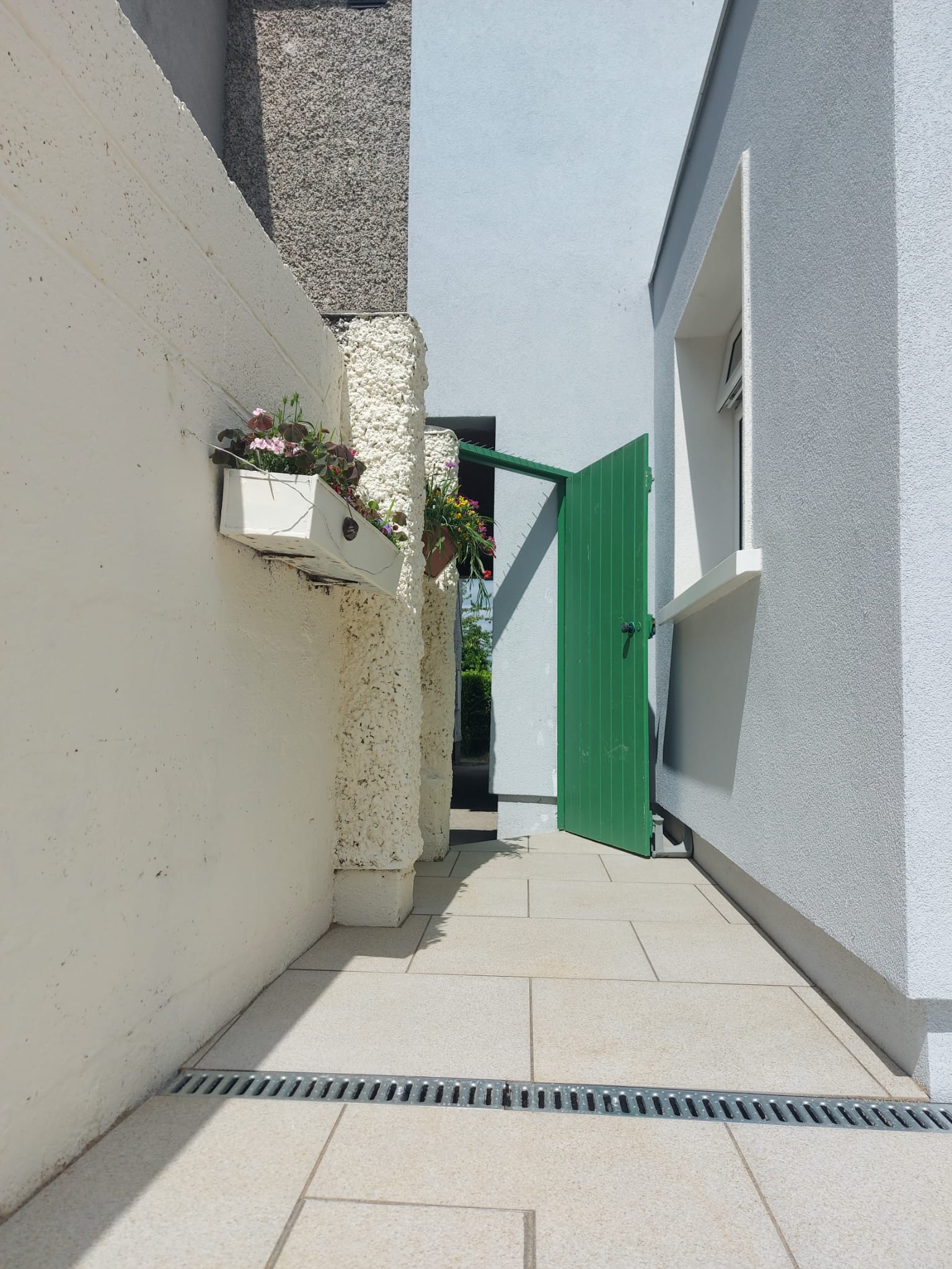 paved walkway from the door of a house